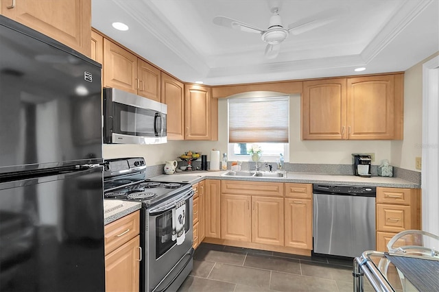 4575 Cove Cir Unit 202, Saint Petersburg, FL 33708 - kitchen with appliances with stainless steel finishes, a raised ceiling, dark tile patterned floors, light countertops, and ceiling fan