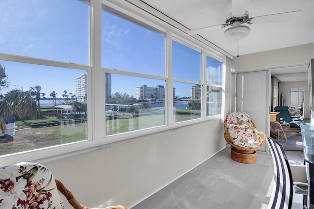 sunroom / solarium featuring ceiling fan and a healthy amount of sunlight