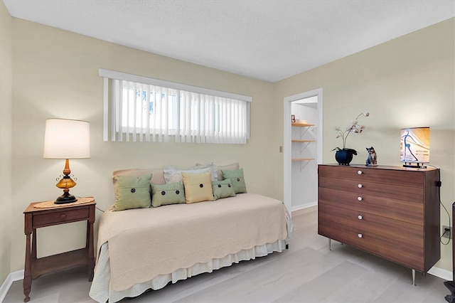 bedroom with a walk in closet and a closet