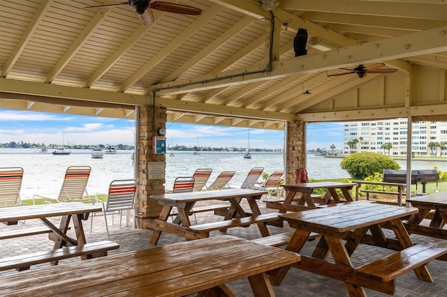 view of patio / terrace with a gazebo, ceiling fan, and a water view