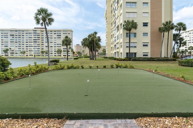 view of community featuring a water view and a lawn