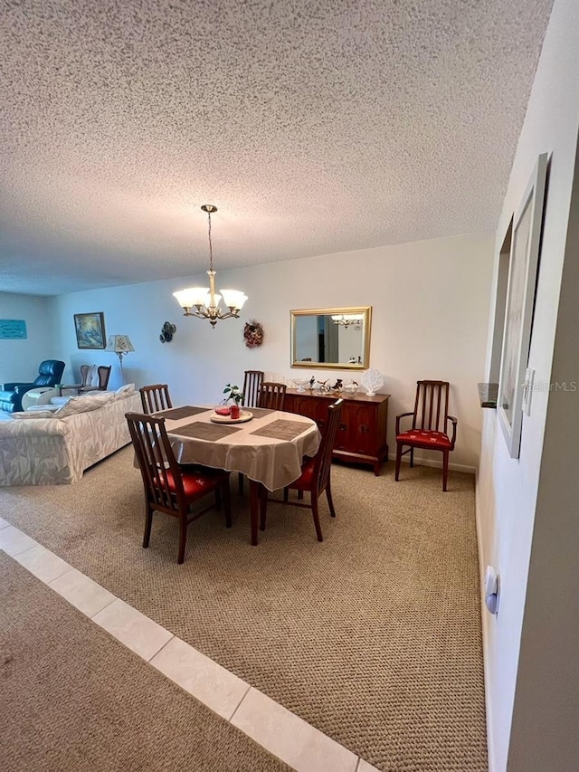 carpeted dining room featuring a textured ceiling and an inviting chandelier