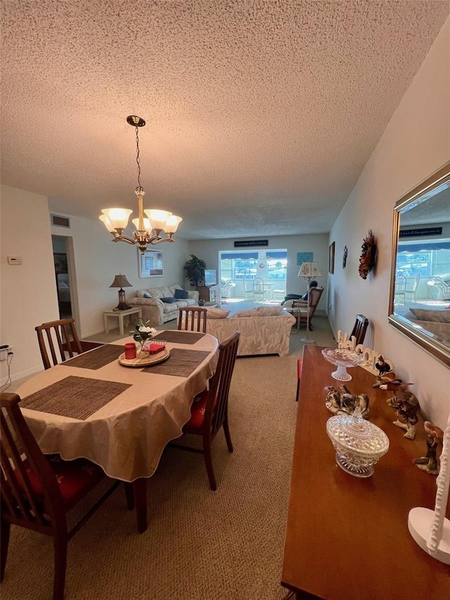 carpeted dining area featuring a textured ceiling and a notable chandelier