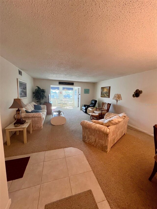 living room with tile patterned floors and a textured ceiling