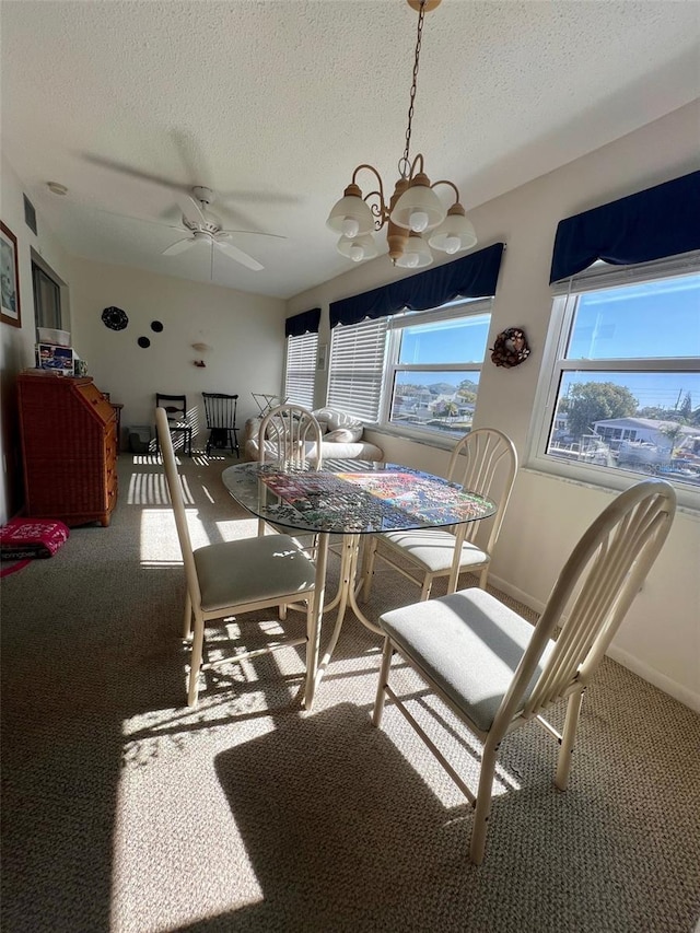 4660 Marine Pkwy Unit 202, New Port Richey, FL 34652 - dining space featuring carpet, a textured ceiling, a chandelier, and baseboards