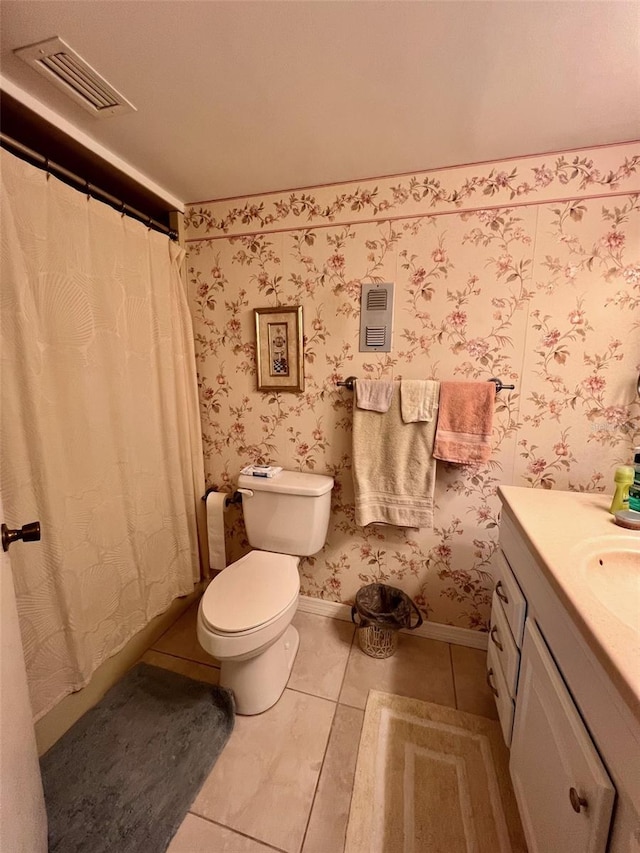 bathroom featuring tile patterned floors, vanity, and toilet