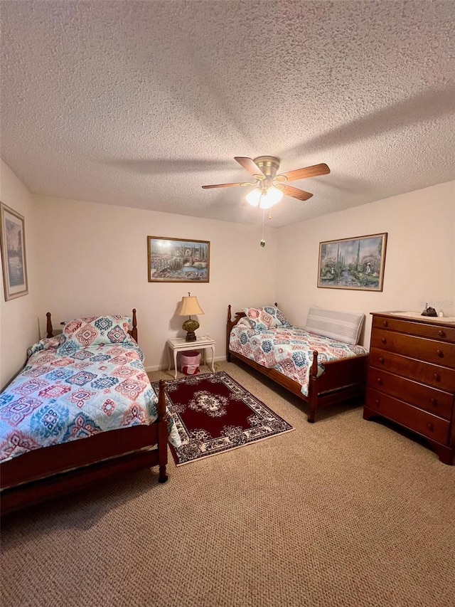 bedroom with ceiling fan, light carpet, and a textured ceiling