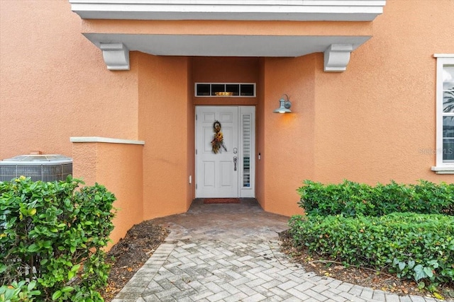 doorway to property with central AC unit