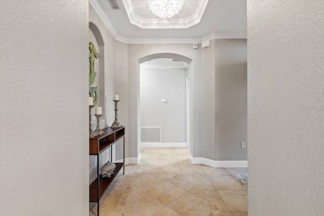 hallway featuring ornamental molding and a notable chandelier