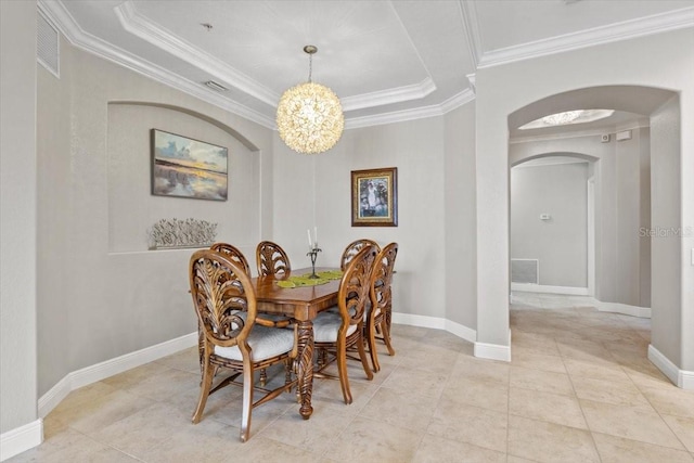 dining room featuring a tray ceiling, an inviting chandelier, and ornamental molding