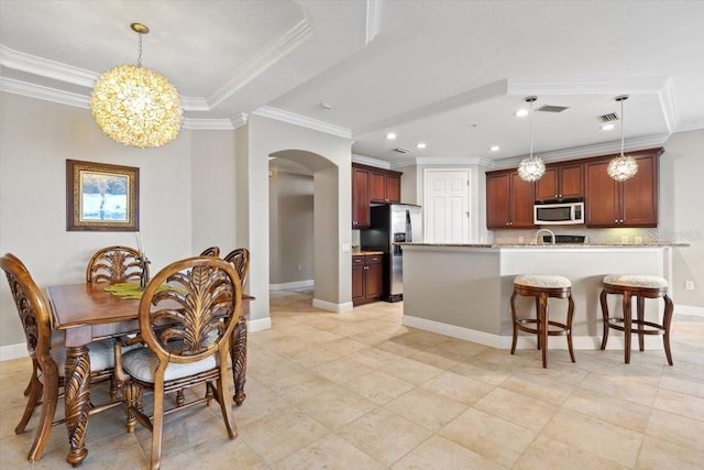 dining room featuring sink, crown molding, and a notable chandelier