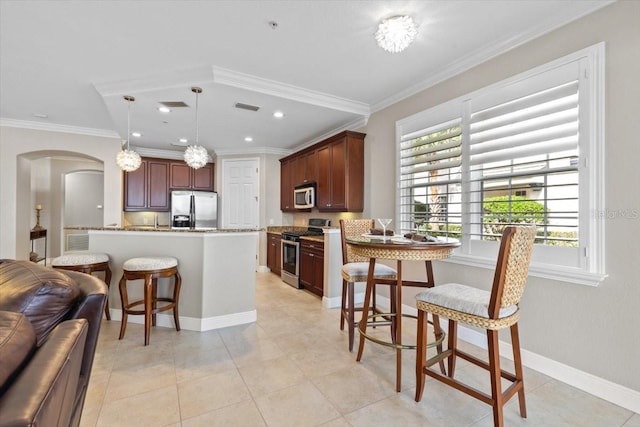 kitchen with crown molding, decorative light fixtures, light tile patterned flooring, light stone counters, and stainless steel appliances