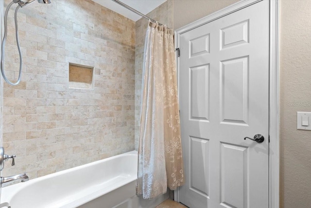 bathroom featuring shower / tub combo with curtain