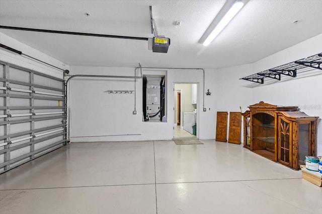 garage with washer / clothes dryer and a garage door opener