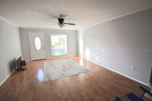 entrance foyer with hardwood / wood-style flooring, ceiling fan, and ornamental molding