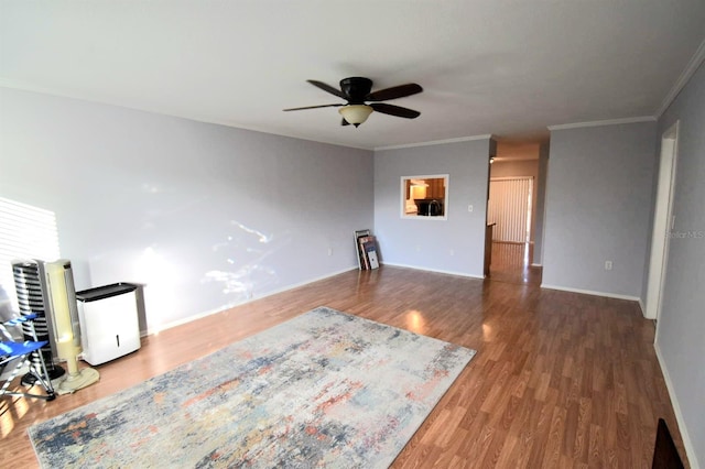 unfurnished living room featuring hardwood / wood-style flooring, ceiling fan, and ornamental molding