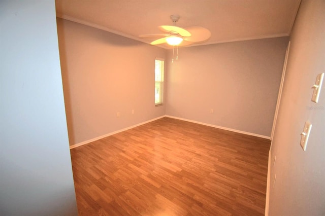 unfurnished room featuring hardwood / wood-style flooring, ceiling fan, and crown molding