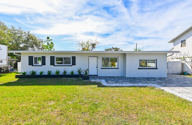 ranch-style home with a front lawn