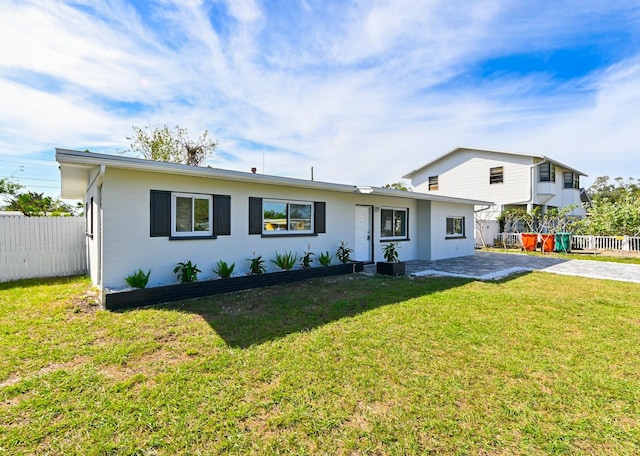 view of front of house featuring a patio and a front lawn