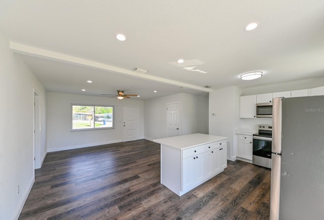 kitchen featuring white cabinets, dark hardwood / wood-style floors, a center island, and stainless steel appliances