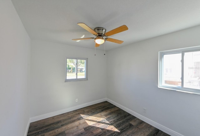 empty room with dark hardwood / wood-style floors and ceiling fan