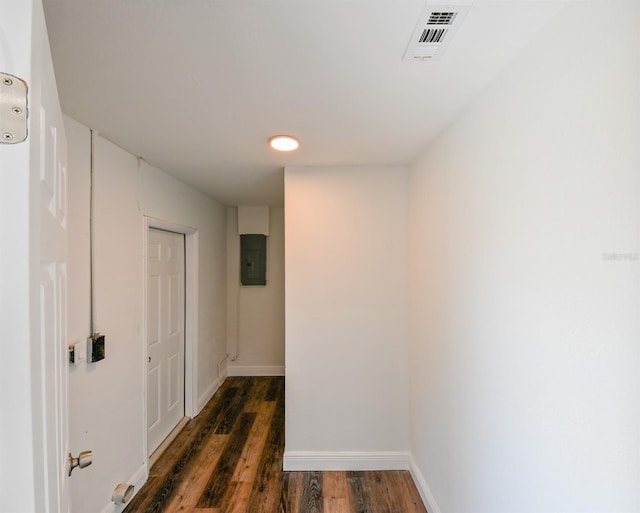 corridor featuring dark hardwood / wood-style flooring and electric panel