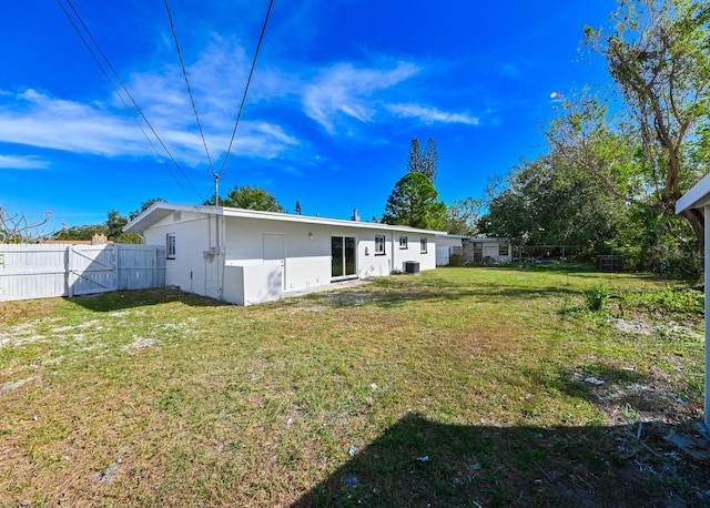 rear view of house featuring a lawn