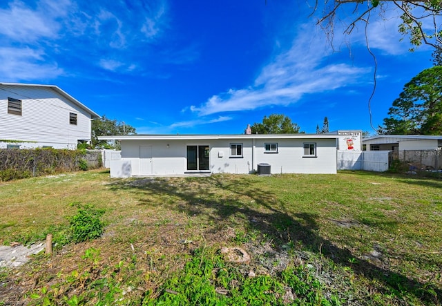 back of house with a yard and cooling unit