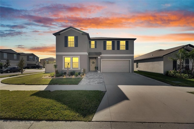 view of front of home with a lawn and a garage