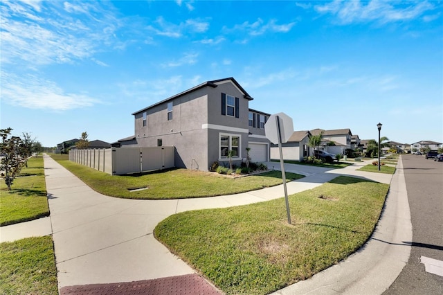 view of side of property with a lawn and a garage