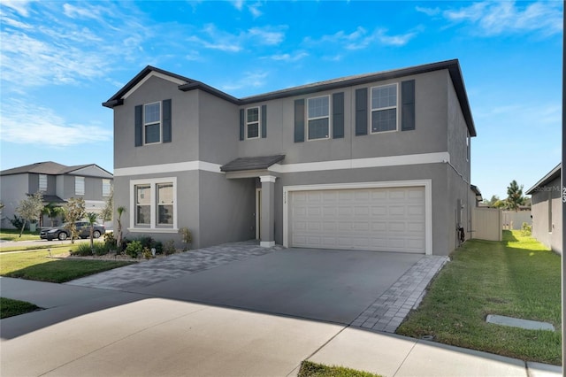 view of front of home featuring a front yard and a garage