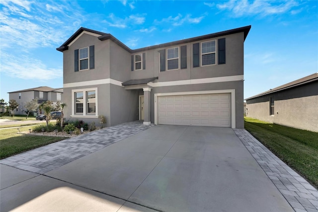 view of front facade with a garage and a front lawn