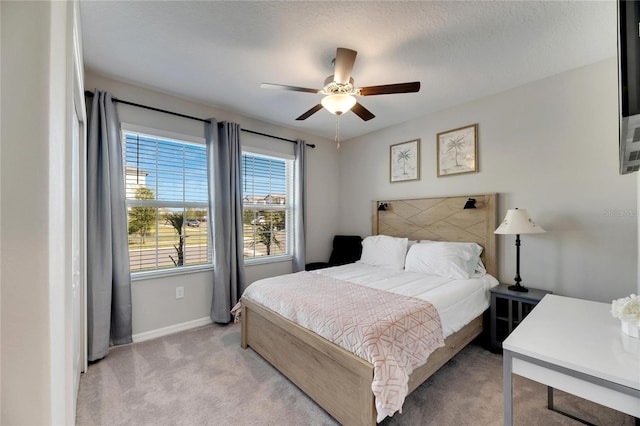 bedroom featuring ceiling fan and light colored carpet