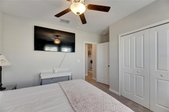 carpeted bedroom featuring ceiling fan and a closet