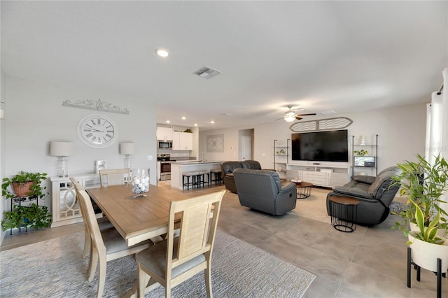 tiled dining space with ceiling fan