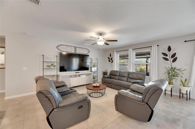 tiled living room with a textured ceiling and ceiling fan