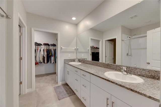 bathroom featuring vanity, tile patterned floors, and a shower with shower door