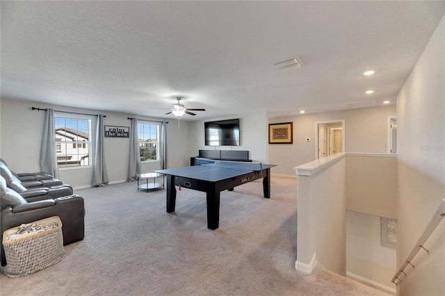 recreation room with ceiling fan and light colored carpet