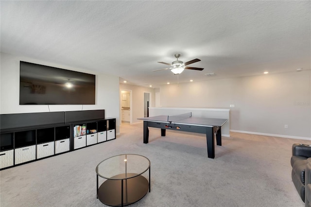 playroom featuring a textured ceiling, ceiling fan, and light carpet