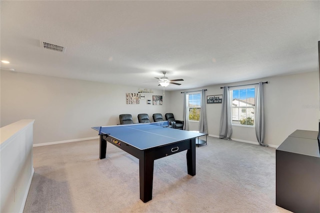 playroom with ceiling fan and light colored carpet