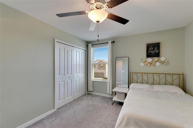 carpeted bedroom with a closet and ceiling fan