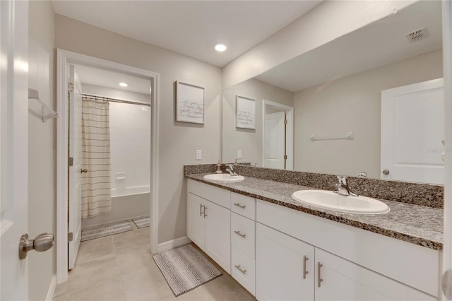 bathroom with tile patterned flooring, vanity, and shower / tub combo