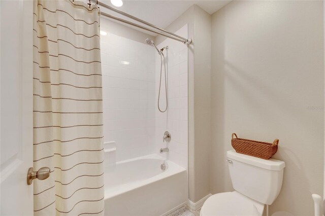 bathroom with toilet and shower / bathtub combination with curtain