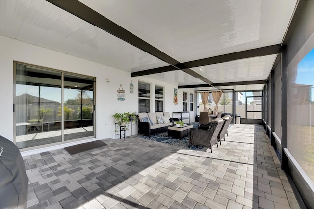 sunroom with beamed ceiling