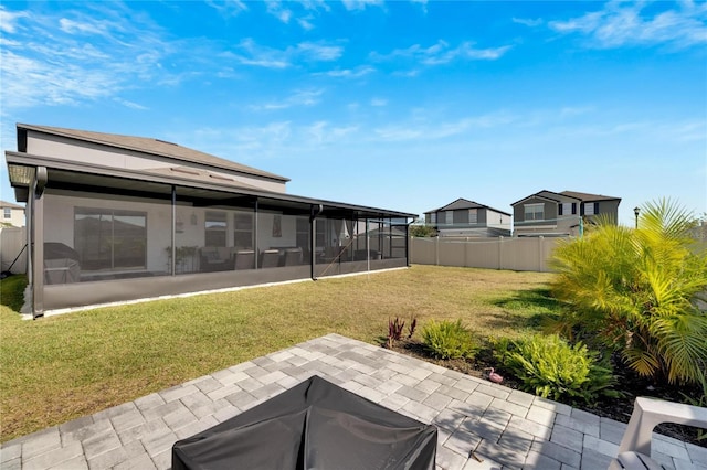 view of yard with a sunroom and a patio