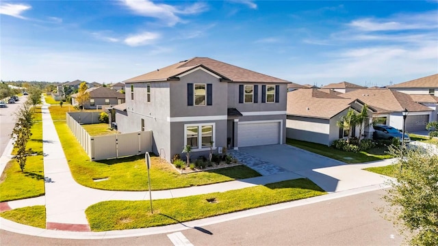 view of property featuring a front lawn and a garage