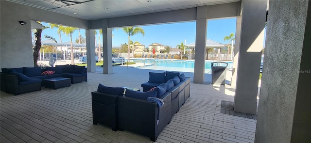 view of patio / terrace with a swimming pool side deck, an outdoor living space, and ceiling fan