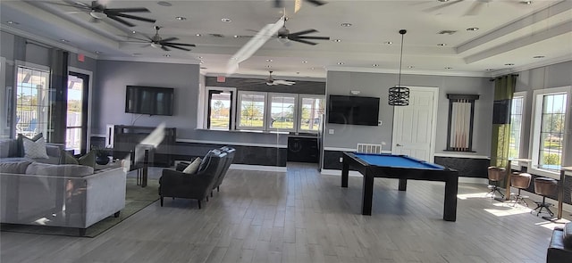 rec room with a tray ceiling, ornamental molding, wood-type flooring, and pool table