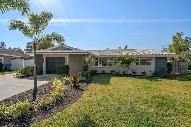 single story home featuring a garage and a front lawn