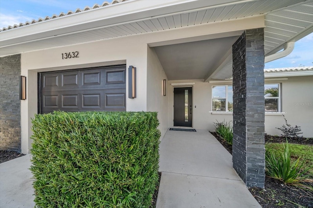 view of exterior entry with a garage